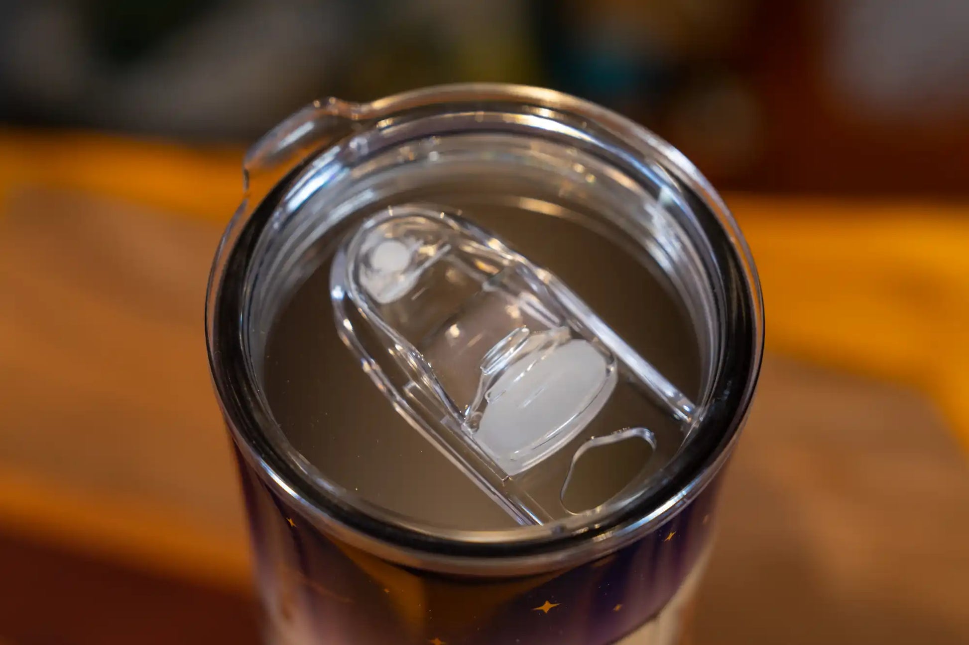 Close-up of a Lake Clear Lodge tumbler leak-proof lid with sliding closure.