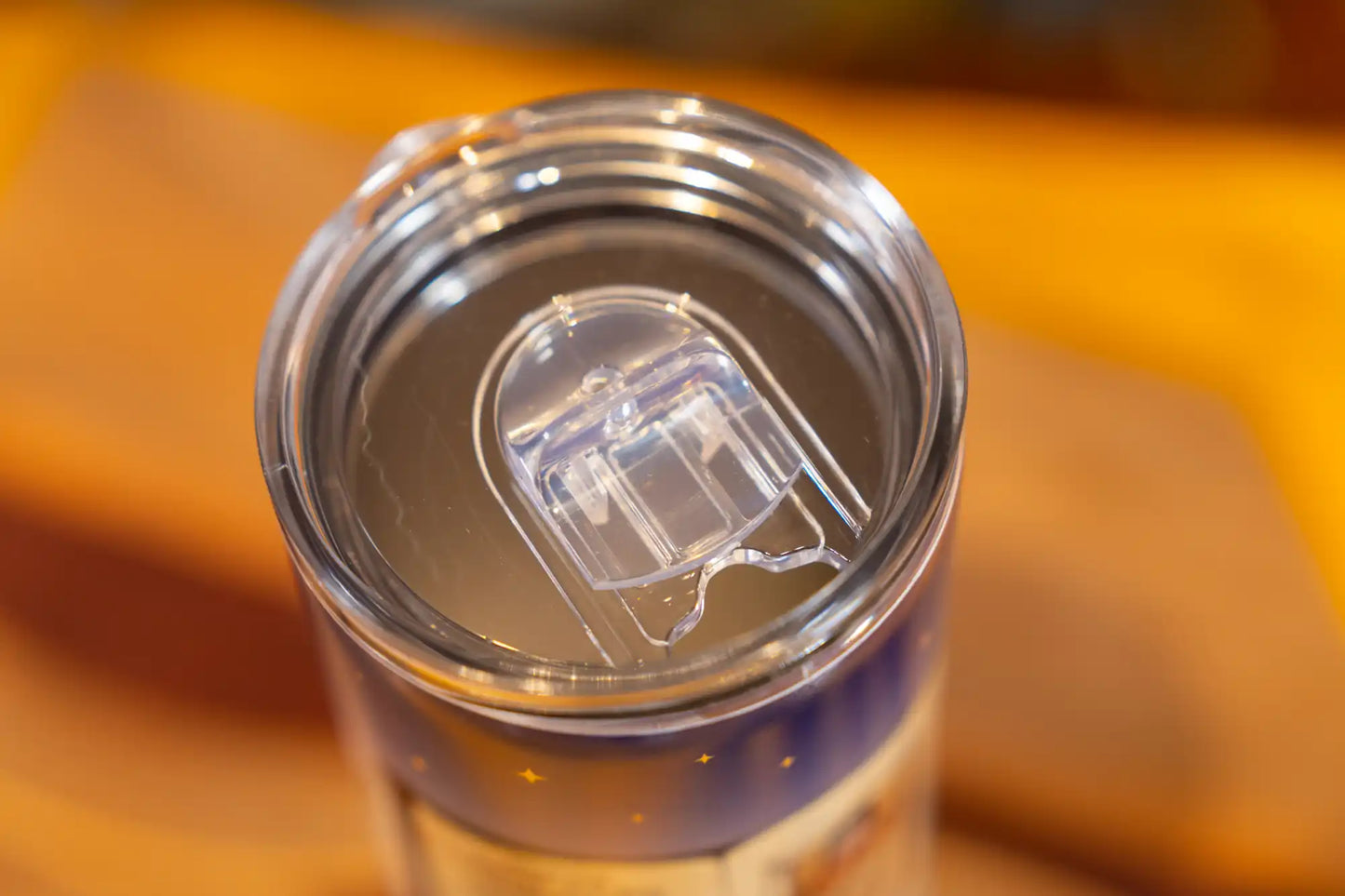 Close-up of the splash-proof sliding lid on a Lake Clear Lodge tumbler.