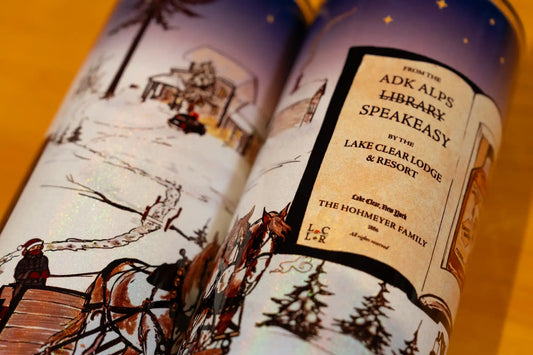 Close-up detail of the hand-drawn artwork on two Lake Clear Lodge holographic shimmer tumbler.